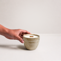 Ishi Candle with hand reaching toward vessel